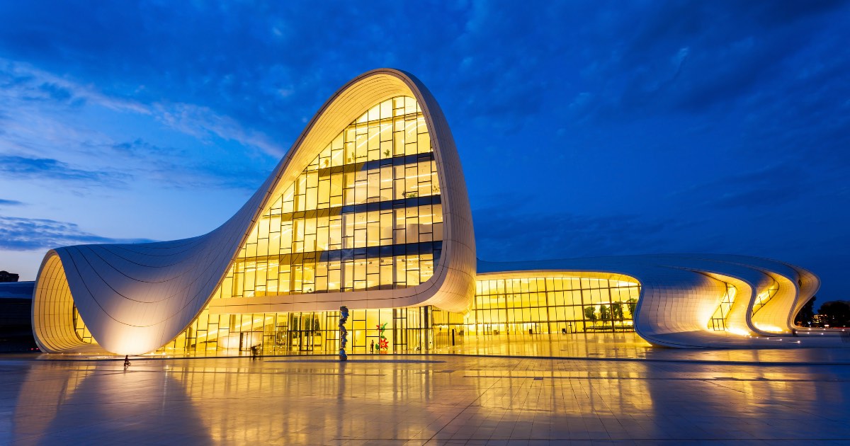 Heydar Aliyev Center by Zaha Hadid glowing at dusk